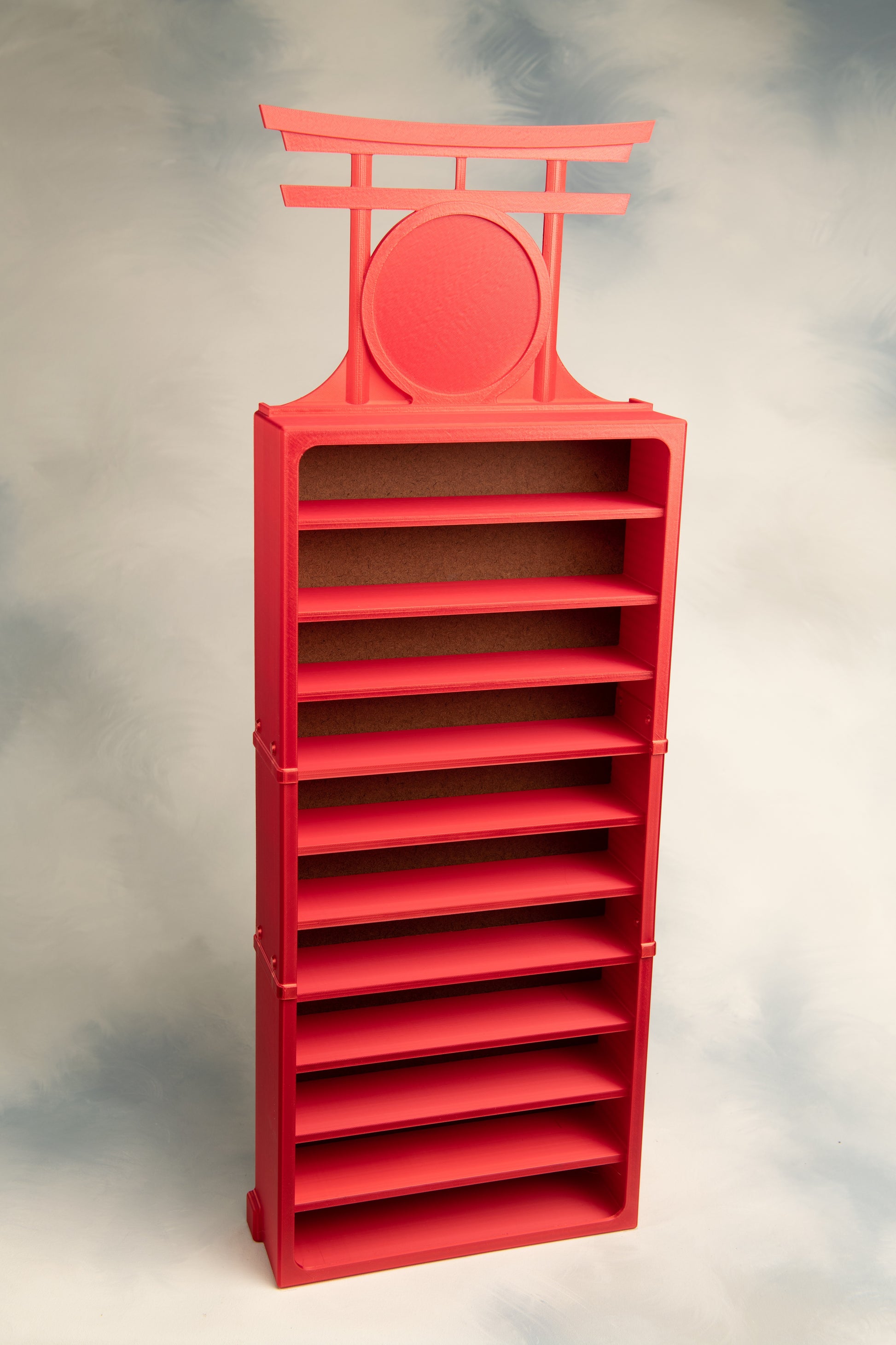 Red 11 belt display with a Torii Gate Topper on a gray background