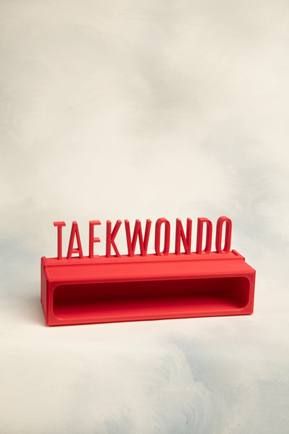 Red 1 belt display case with a 'TAEKWONDO' topper on a light background