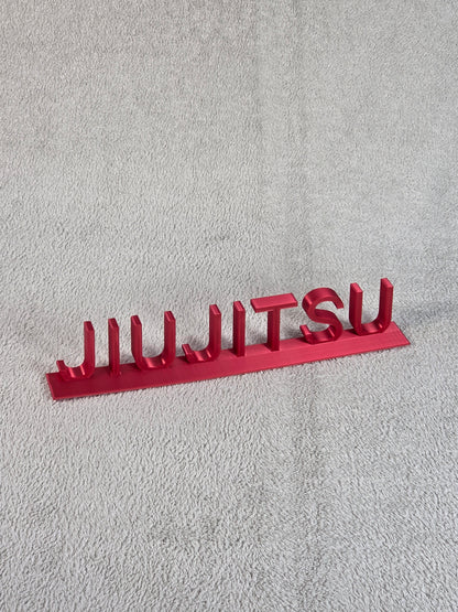 Red 'Juijitsu' sign on a textured gray surface