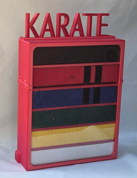 Red case with 'KARATE' sign with belts displayed 