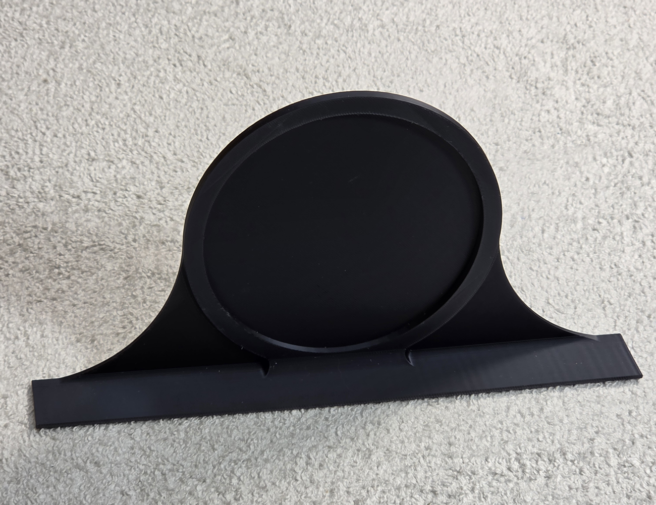 Black decorative topper with a round patch area on a light gray background