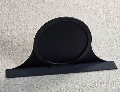 Black decorative topper with a round patch area on a light gray background