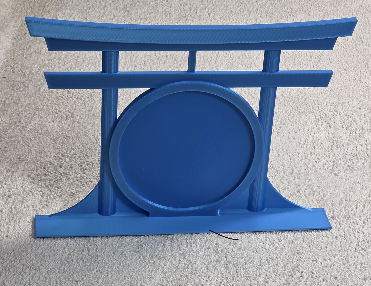 Blue decorative topper with a round patch area in front of a torii gate on a light gray background