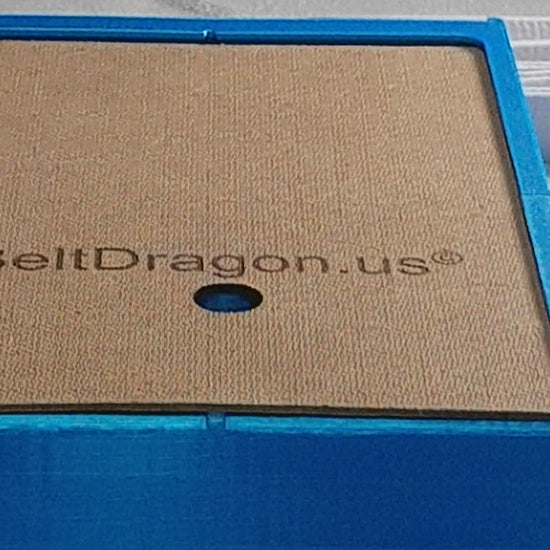 Video displaying how to load a belt into case by sliding off the back cover, inserting the tail of a belt after folding belt in half and weaving belt back and forth and finally, replacing the back cover by sliding the back into slot past the locking tab